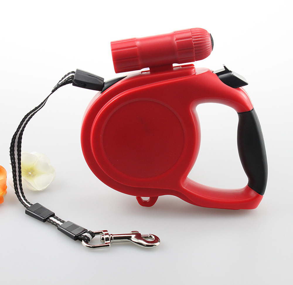 Red retractable dog leash with durable plastic housing and bag dispenser